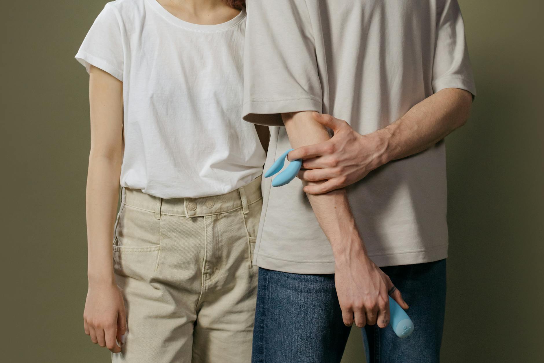 A person holding lemon vibrators against a textured background, symbolizing intimate wellness